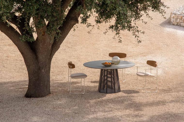 Outdoor dining set by Potocco under a tree