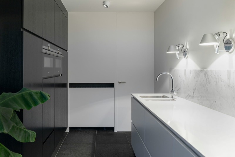 Renovated kitchen and utility space with dark joinery